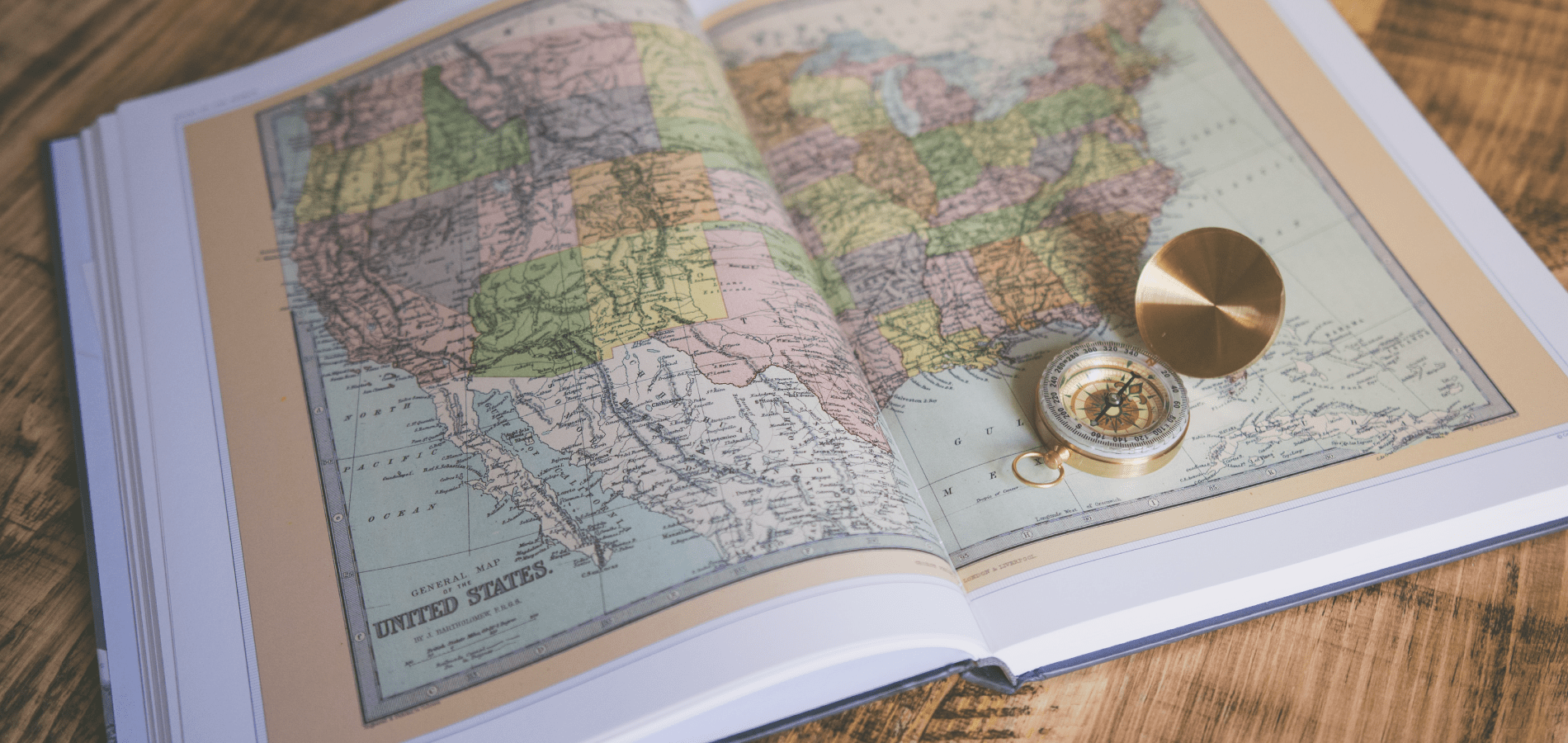 Book with map of the united states and a compass