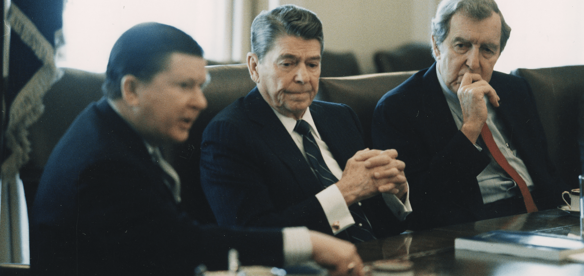 President Reagan (center) receives the Tower Commission Report in the White House Cabinet Room
