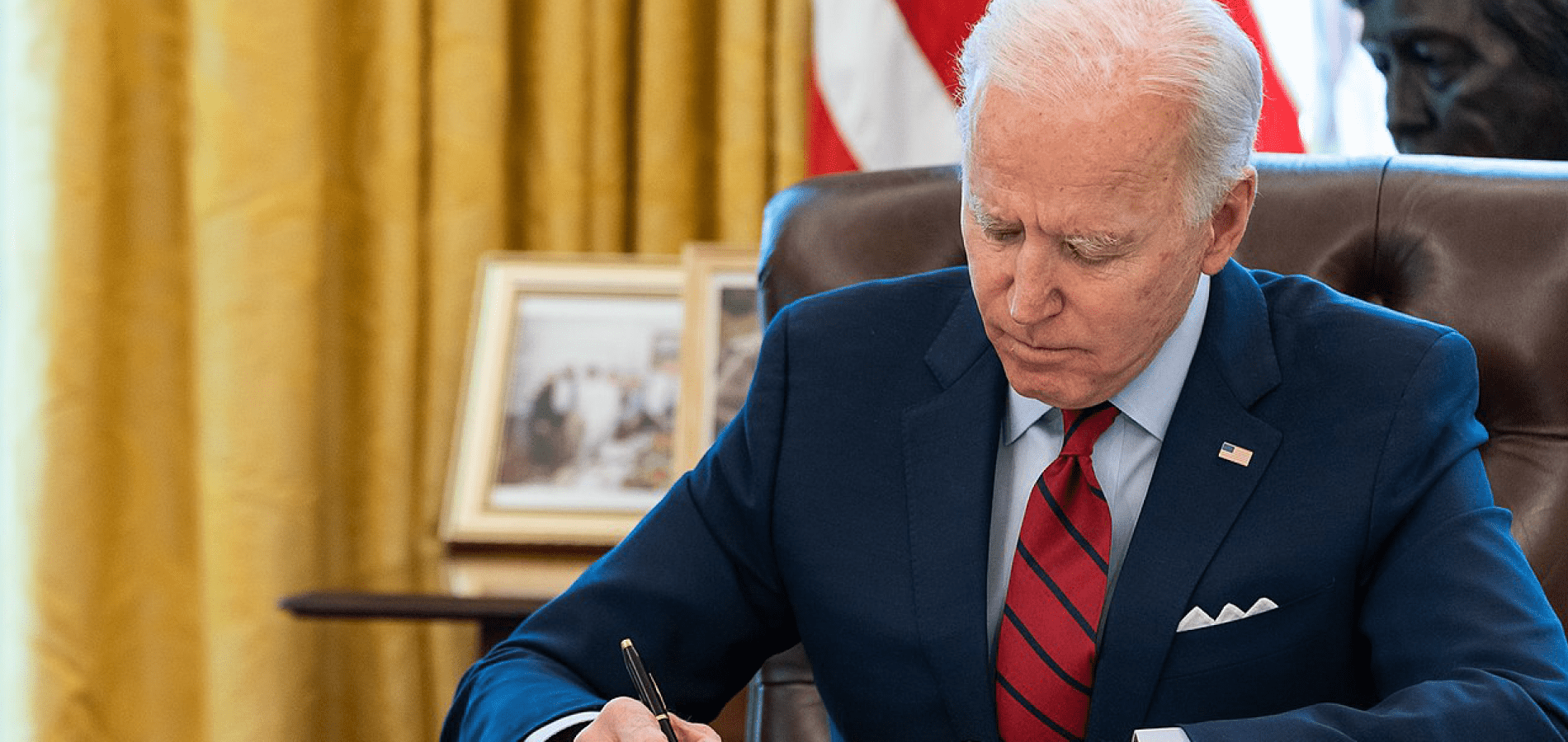 President Joe Biden signing documents