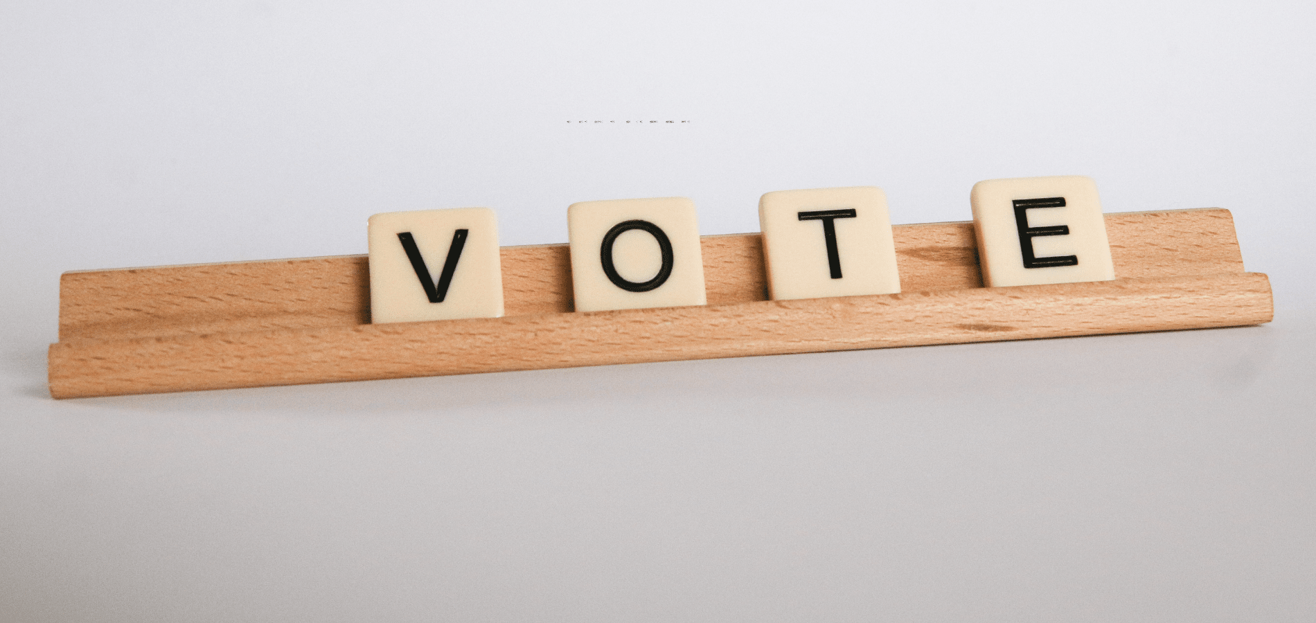 the word "vote" in scrabble tiles