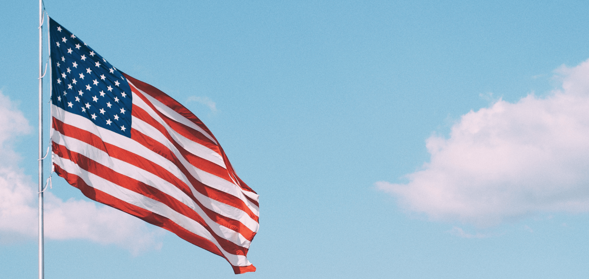 image of American flag against blue sky