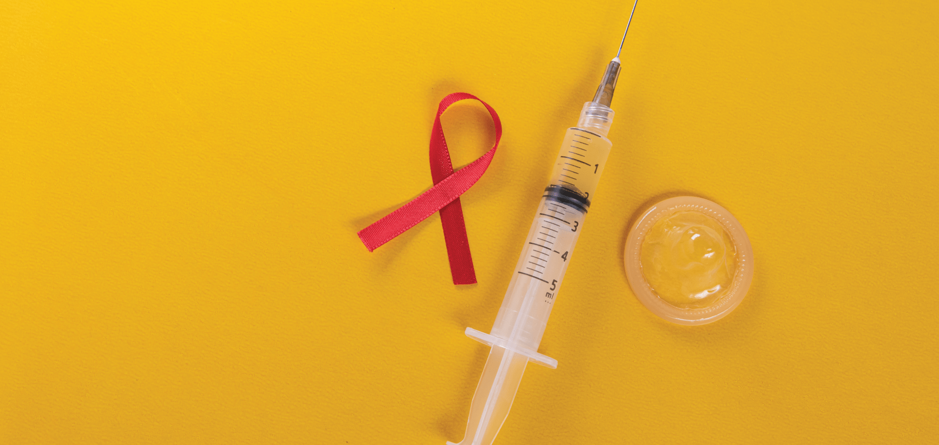 image of red ribbon, syringe and condom