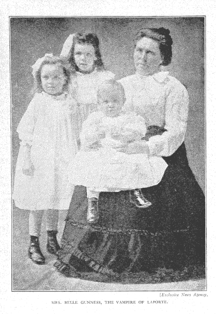 A photograph of Belle Gunness, seated, with her infant son seated on her lap. To her right stand her two young daughters.