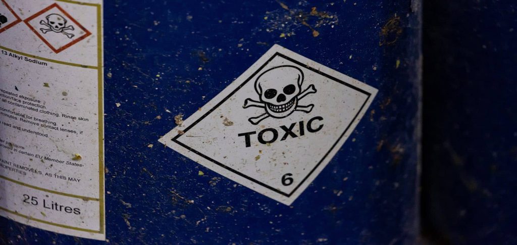 Blue steel barrel with a skull and crossbones label with the word "toxic"