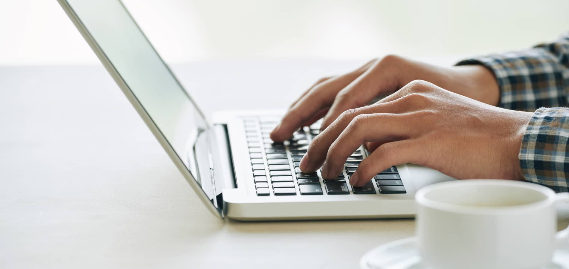 image of a person typing on a computer