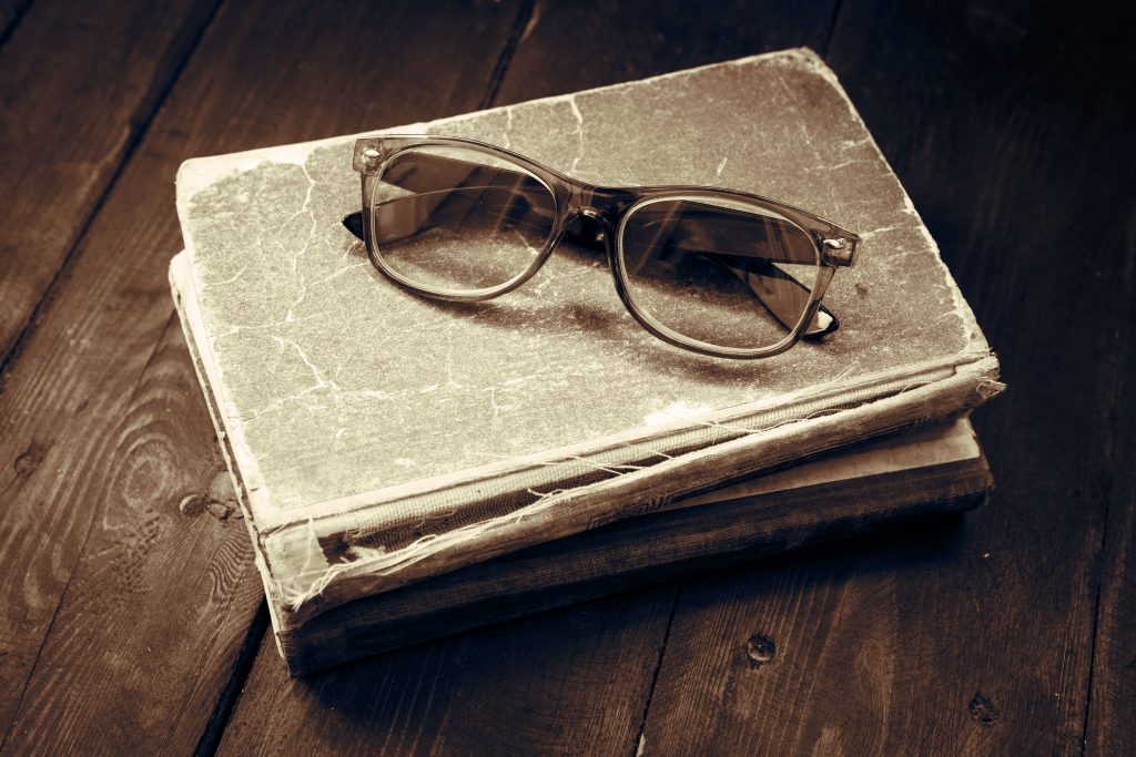 image of old books and glasses