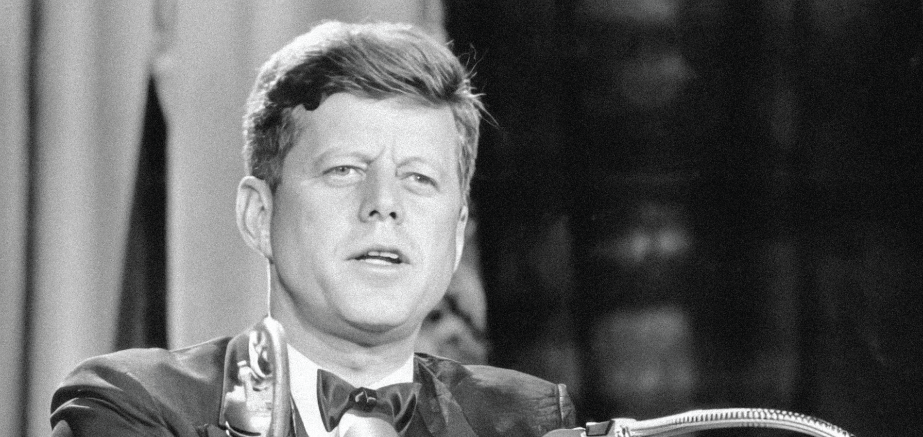 John F. Kennedy speaking at a podium