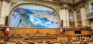 Image of a empty government room with statutes and the Swiss flag