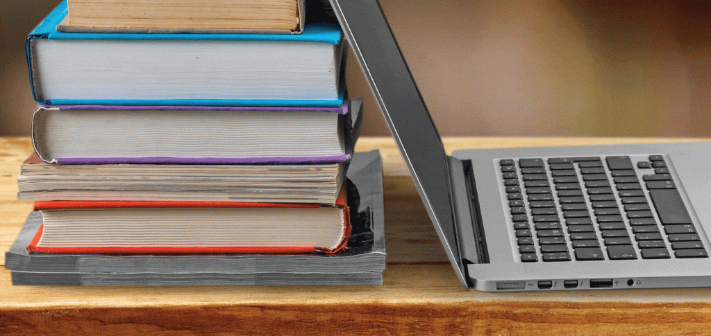 image of laptop and a stack of books