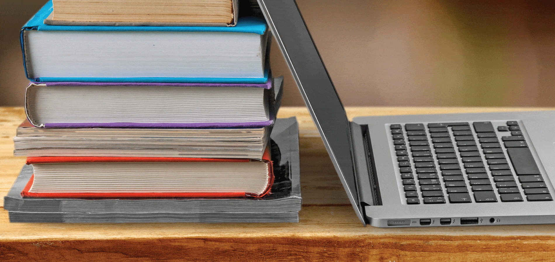 image of laptop and a stack of books