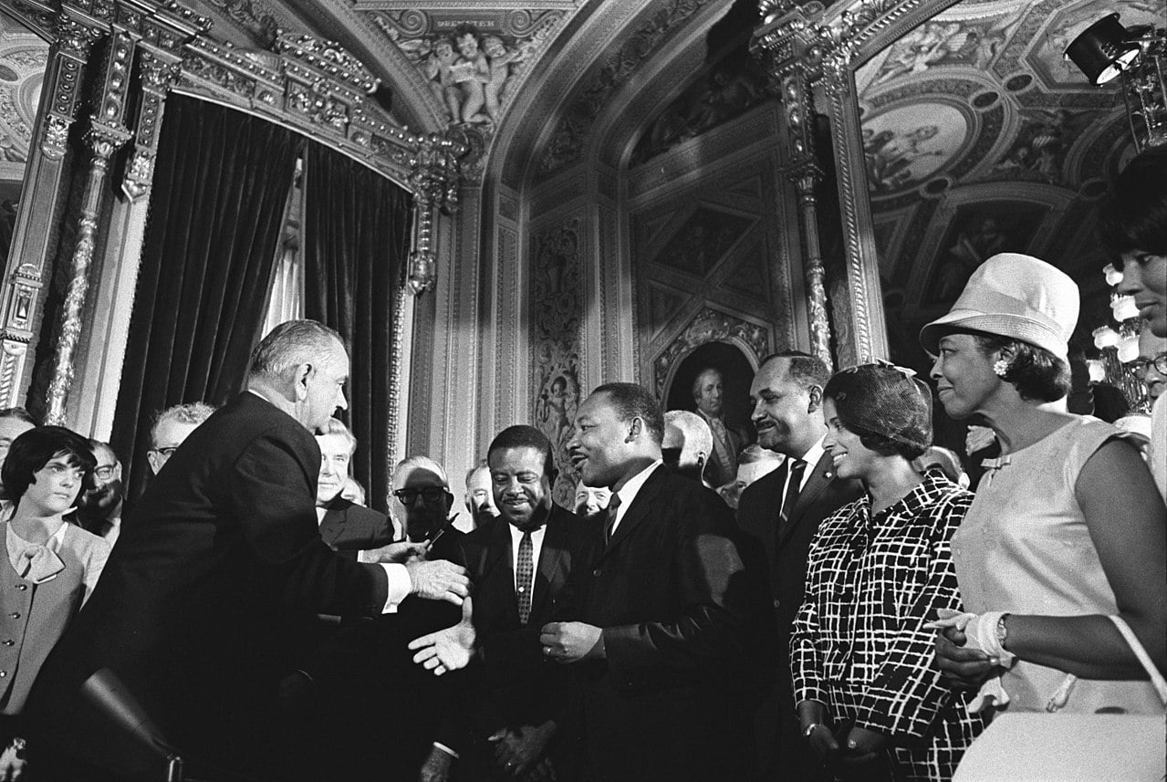 President Lyndon B. Johnson is joined by civil rights leaders to sign the Voting Rights Act of 1965