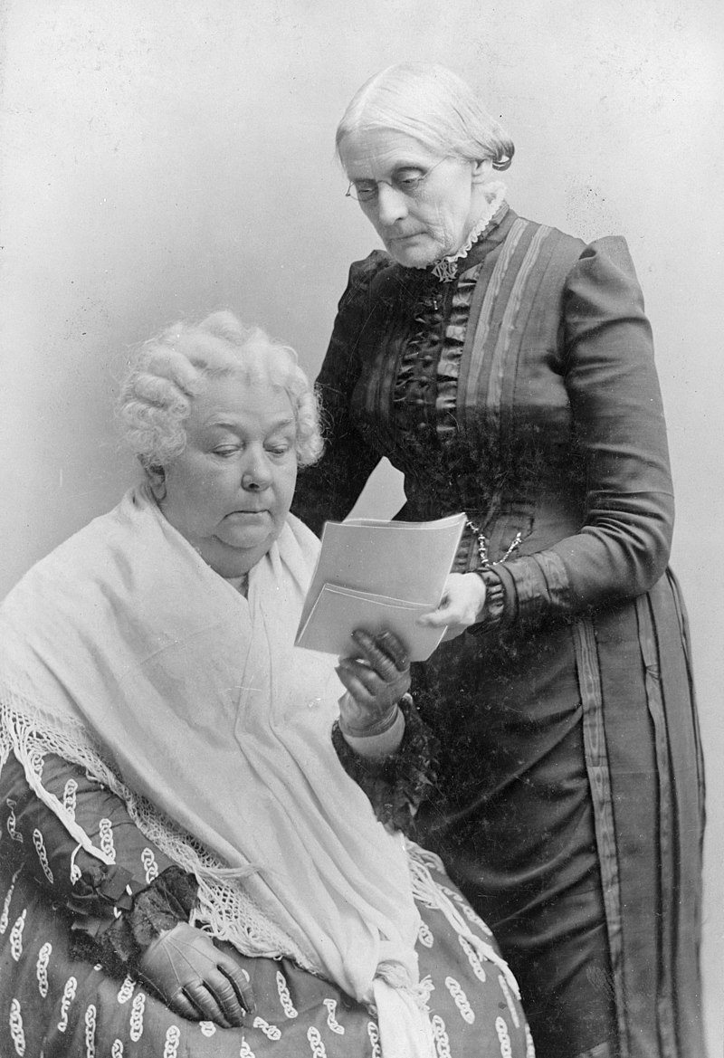 Elizabeth Cady Stanton and Susan B. Anthony looking at a piece of paper.