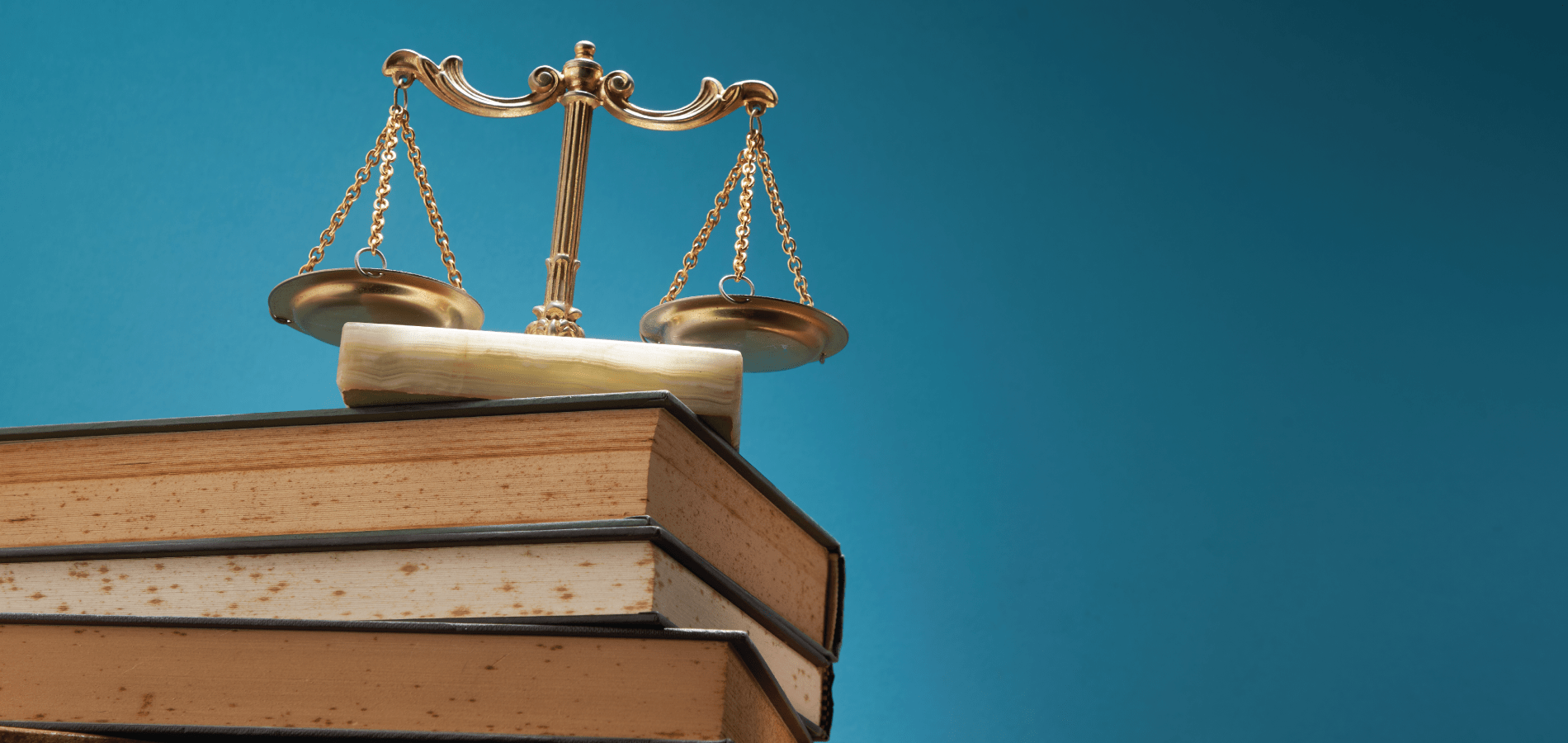 stack of books with a balance scale on top