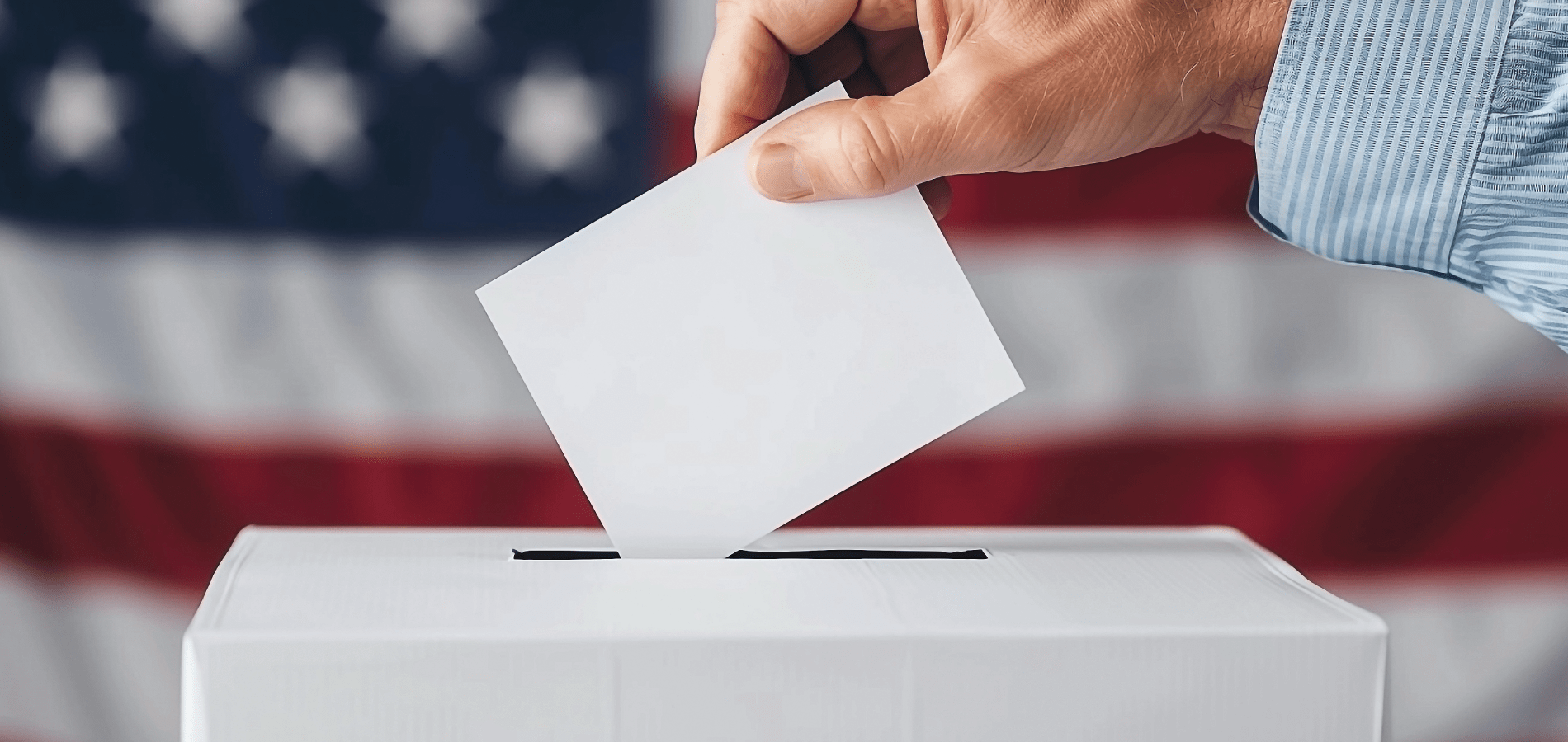 voter putting ballot in ballot box