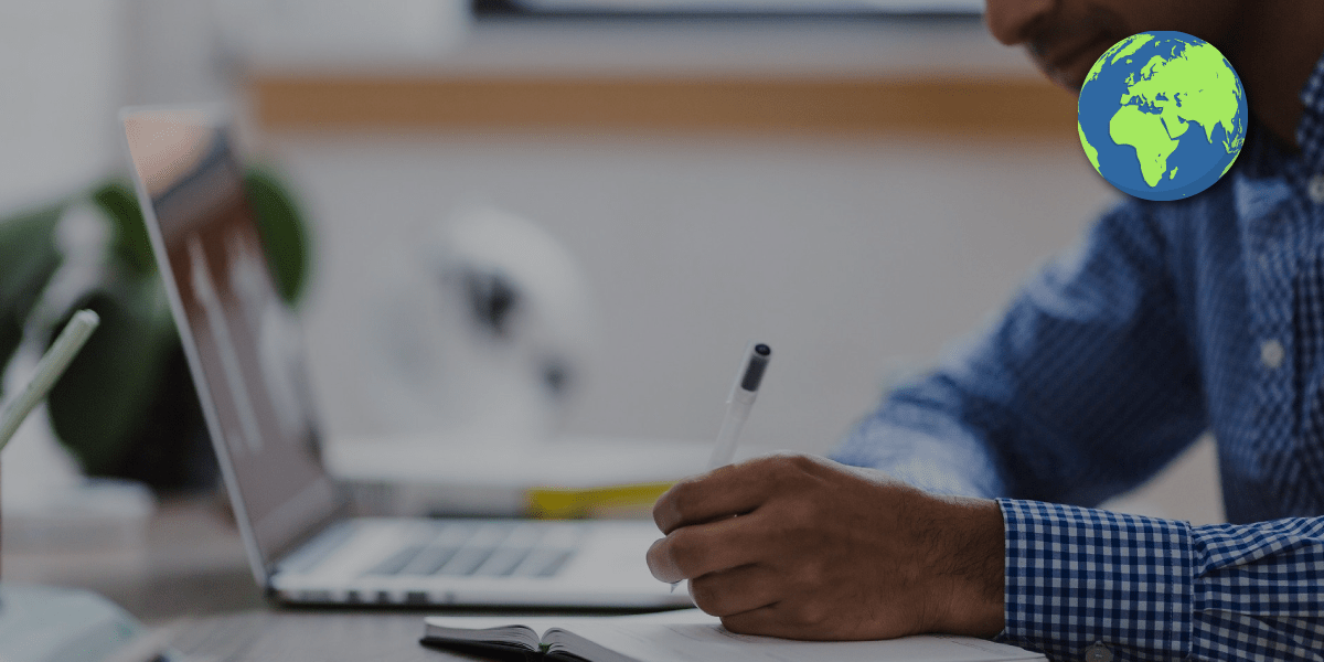 Man at a laptop with a notebook