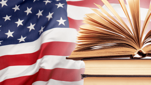 stack of books with American flag in the background